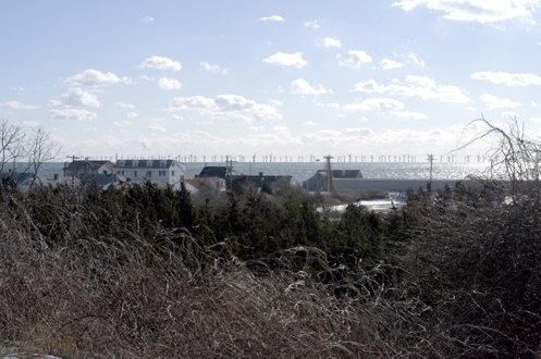 DOZENS OF WIND TURBINES are shown as they will look roughly 6.5 miles out from the shore in Barnstable, Mass., in a rendering of the proposed Cape Wind project provided by the developer. / DOZENS OF WIND TURBINES are shown as they will look roughly 6.5 miles out from the shore in Barnstable, Mass., in a rendering of the proposed Cape Wind project provided by the developer. /