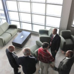 New mission for Quonset State Airport TAKING FLIGHT: Airport officials tour the recently finished terminal and
hangar at Quonset. The new terminal is expected to increase traffic at the
North Kingstown airport. /