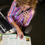 Learning the product part of the fun at Collette GLOBE TROTTING: Collette Vacations employee Lisa Corrente-Bruce at work in the company’s Pawtucket office. /