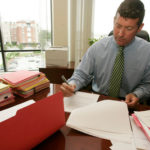 PART OF THE TEAM: Nixon Peabody Partner Joseph B. White works in his office. The &ldquo;One Firm&rdquo; initiative promotes the idea of team spirit at the global firm. / 