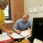 Despite growth, Shechtman proud to think small LAW OF THE LAND: Paralegal Elaine Smith looks over a file with attorney Bill Dorry at Shechtman Halperin & Savage LLP offices. /