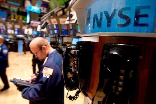 TRADERS WORK ON THE FLOOR of the New York Stock Exchange last week. Two Rhode Island companies are slated to be added to the widely-followed Russell 3000 stock index this week. / TRADERS WORK ON THE FLOOR of the New York Stock Exchange last week. Two Rhode Island companies are slated to be added to the widely-followed Russell 3000 stock index this week. /