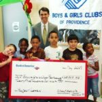 WILLIAM F. HATFIELD, president of Bank of America Rhode Island, presents a check for $25,000 to children at the Boys & Girls Clubs of Providence. / 