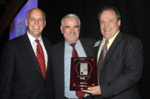 Cox Business S.V.P. Mark Scott accepts his sponsor plaque  / PBN PHOTO/FRANK MULLIN