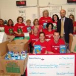 ANDREW SCHIFF, executive director of the Rhode Island Community Food Bank, stands with Bank of America volunteers of the Westminster Street and Dupont Drive Bank of America offices. / 