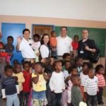 COLLETTE VACATIONS employees standing with the teacher and children from the Knysna local preschool in South Africa are, from left, Derek Moscarelli, tour manager; Sue Rovinski, graphic designer; Frank Marini, vice president of sales; Jim Marini, district sales manager. / 