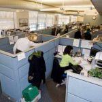 PUTTING IN WORK: The Department of Labor and Training call center employees, shown above in February, work overtime and Sundays to eliminate the backlog. / 