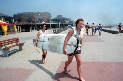 FOREIGN LAND: Exchange students Alisa Mohr, left, of Germany and Melissa Grant of New Zealand on Easton’s Beach in Newport last week. Bad weather and a down economy have impacted Aquidneck Island’s tourism business this summer. / FOREIGN LAND: Exchange students Alisa Mohr, left, of Germany and Melissa Grant of New Zealand on Easton’s Beach in Newport last week. Bad weather and a down economy have impacted Aquidneck Island’s tourism business this summer. /