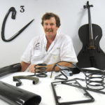 SOUND OF SUCCESS: Clear Carbon & Components Corp. President Matt Dunham poses with various products that use carbon fibers, including a cello and a license plate frame. / 