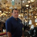CROWNING ACHIEVEMENT: Bill Donahue, owner of Crown Supply, stands among some of the lighting fixtures at the Providence location. / 