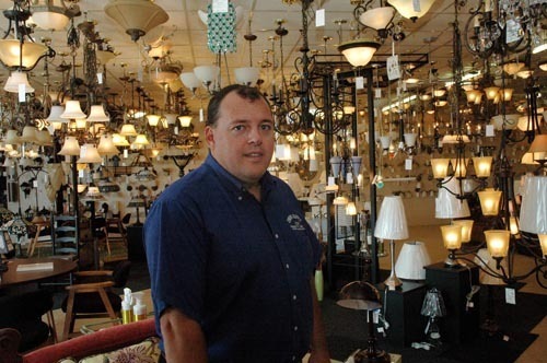 CROWNING ACHIEVEMENT: Bill Donahue, owner of Crown Supply, stands among some of the lighting fixtures at the Providence location. / CROWNING ACHIEVEMENT: Bill Donahue, owner of Crown Supply, stands among some of the lighting fixtures at the Providence location. /