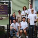STAFF FROM DiSanto, Priest & Co. planted shrubs and perennials in the yard at Sojourner House. Pictured bottom row, from left: Mark Carrison, Angela Paolino; back row: Chris Ricci, Dawn Wood, Tom Porsythe, Cori Conaty and David DiSanto. / 
