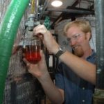 NAT HARRIS, one of the five owners of Newport Biodiesel, is also production manager at the company&rsquo;s Newport facility. Above, he checks filtered oil. / 