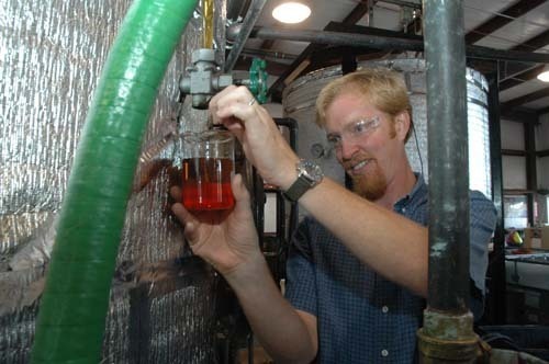 NAT HARRIS, one of the five owners of Newport Biodiesel, is also production manager at the company’s Newport facility. Above, he checks filtered oil. / NAT HARRIS, one of the five owners of Newport Biodiesel, is also production manager at the company’s Newport facility. Above, he checks filtered oil. /