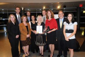 AMGEN VP, Kimball Hall(3rd from right) and staff with their Innovation Champion Award  / PBN PHOTO/FRANK MULLIN