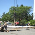 WIND POWER: Workers prepare one of the blades for SGE’s on-site wind turbine which, along with new solar panels, will help power the company’s Middletown office building. / 