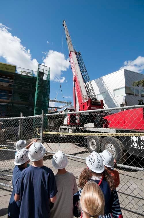 STUDENTS watch the topping off of the Wheeler School’s 10,800-square-foot expansion. / STUDENTS watch the topping off of the Wheeler School’s 10,800-square-foot expansion. /