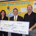 MAUREEN CODY, left, second vice president of the board of directors for the Boys & Girls Club of Taunton, and Robert McGarva, right, executive director, accept a check from Joseph T. Baptista Jr., middle, president and CEO of Mechanics Cooperative Bank, in support of the fundraising campaign. / 