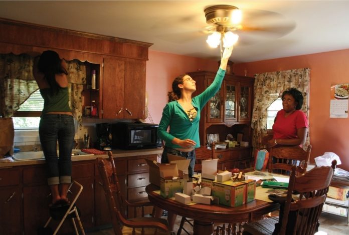 BROWN STUDENTS have replaced inefficient incandescent light bulbs with compact fluorescents in more than 4,900 low-income households in Providence. / BROWN STUDENTS have replaced inefficient incandescent light bulbs with compact fluorescents in more than 4,900 low-income households in Providence. /
