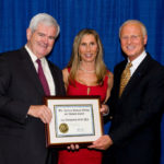FORMER HOUSE SPEAKER Newt Gingrich, left, presents an award to Richard Schloesser, right, president and CEO of Toray Plastics (America), and his wife, Janet. / 