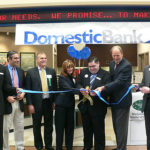 DOMESTIC BANK OFFICIALS cut the ribbon at the opening of a new branch inside a Wal-Mart store in Northbridge, Mass., in April 2007. / 