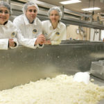 SAY CHEESE: From left, Narragansett Creamery’s Pattie Federico, Mark Federico and Louella Hill, with a batch of curds and whey in the company’s Providence production facility. / 