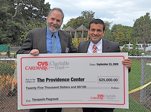DALE K. KLATZKER, president and CEO of The Providence Center, left, is presented with a $25,000 check from CVS Caremark Charitable Trust, represented by Manager of Community Relations Randy Martinez. / DALE K. KLATZKER, president and CEO of The Providence Center, left, is presented with a $25,000 check from CVS Caremark Charitable Trust, represented by Manager of Community Relations Randy Martinez. /