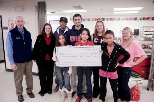 FRONT ROW, FROM LEFT: Urban Collaborative Accelerated Program students Lynet Gonzalez, Bianca Archila and Carla Perez-Nunez receive a $10,500 check for their school from URI’s Greek community members. Back row from left: URI Greek community members Steve Simo, coordinator of Greek affairs; Jenna Winkler, graduate assistant; Jean Aubourg, Omega Psi Phi; Max Moss, Beta Theta Pi; Meg Curran, Sigma Kappa; Lauren DiStefano, Zeta Tau Alpha. / FRONT ROW, FROM LEFT: Urban Collaborative Accelerated Program students Lynet Gonzalez, Bianca Archila and Carla Perez-Nunez receive a $10,500 check for their school from URI’s Greek community members. Back row from left: URI Greek community members Steve Simo, coordinator of Greek affairs; Jenna Winkler, graduate assistant; Jean Aubourg, Omega Psi Phi; Max Moss, Beta Theta Pi; Meg Curran, Sigma Kappa; Lauren DiStefano, Zeta Tau Alpha. /