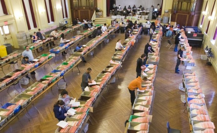 TEMPORARY WORKERS at Brown University fill 300 boxes in Alumnae Hall with the record 30,000 applications the school got for the Class of 2014. / 