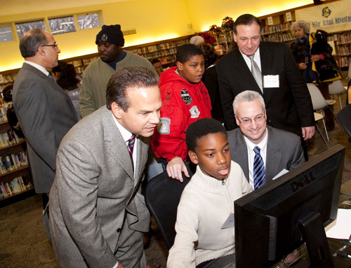 PROVIDENCE MAYOR David N. Cicilline, front left, and GTECH Regional Vice President Jay Gendron, front right, watch a student work with one of the new computers in the After School Advantage Lab at the Mt. Pleasant Library, as Councilman John J. Lombardi, back left, talks with a library patron. / PROVIDENCE MAYOR David N. Cicilline, front left, and GTECH Regional Vice President Jay Gendron, front right, watch a student work with one of the new computers in the After School Advantage Lab at the Mt. Pleasant Library, as Councilman John J. Lombardi, back left, talks with a library patron. /