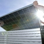 THE EDC HAS RELEASED a plan for boosting the green economy in Rhode Island. Above, workers in Utah install solar panels. / 