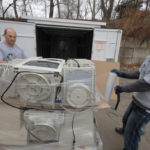 CYCLING IN: Dan Tasho and Justin Reid, right, of Office Recycling Solutions, wrap 
computer monitors to ready them for shipment to be recycled. / 