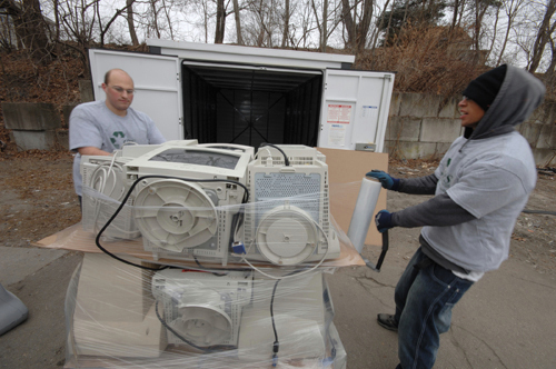 CYCLING IN: Dan Tasho and Justin Reid, right, of Office Recycling Solutions, wrap
computer monitors to ready them for shipment to be recycled. / CYCLING IN: Dan Tasho and Justin Reid, right, of Office Recycling Solutions, wrap
computer monitors to ready them for shipment to be recycled. /