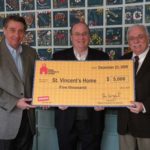 FROM LEFT: Staples District Manager Joe Baxter and Staples regional Vice President 
Bill Madormo present a $5,000 grant check to Saint Vincent’s Executive Director Jack Waldon. / 