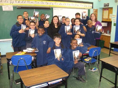 AUTHOR DIANE KOZAK, center, poses with San Miguel School sixth grade teacher Sarah Laitinen, far right, and students. / AUTHOR DIANE KOZAK, center, poses with San Miguel School sixth grade teacher Sarah Laitinen, far right, and students. /