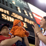 HOME FIELD: Ricardo Ocasio plays with 
9-month-old son Isaiah as his wife, Heather Ocasio, looks on at McCoy Stadium. / 
