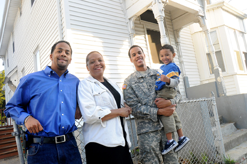 FROM LEFT: Rafael Milan, his mother, Lourdes Milan, brother Jose Milan, and Jose’s
four-year-old son Jamari, in front of their house off Broad Street in Providence. / FROM LEFT: Rafael Milan, his mother, Lourdes Milan, brother Jose Milan, and Jose’s
four-year-old son Jamari, in front of their house off Broad Street in Providence. /