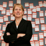 Going national, holding
focus, keep Devlin on toes BRAND AWARENESS: Heidi Devlin, CVS Caremark VP of advertising, in front of her department’s “pad on the back” notice board. /
