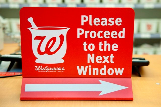 A SIGN DIRECTS CUSTOMERS at a Walgreen pharmacy in New York City last winter. The fight between Walgreen and CVS Caremark escalated Wednesday. / A SIGN DIRECTS CUSTOMERS at a Walgreen pharmacy in New York City last winter. The fight between Walgreen and CVS Caremark escalated Wednesday. /