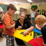 MAKING A DIFFERENCE: Meredith Mitchell, a teacher at A Family Tree day care in Warwick, works with student Austin Wilson, left. The school received a $30,000 
micro-loan in 2008. / 