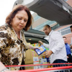 Concierge program keeps
attention on tasks at hand COMMUNICATION SKILLS: Joyce Hurlbut, foreground, a human resources assistant for Cox Communications, helps with a recent
company food drive.
PBN PHOTO/
RUPERT WHITELEY /