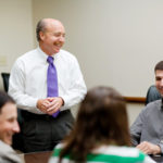 TEAMWORK: Allan Litwin, standing, managing partner at KLR, addresses employees during a 
weekly team meeting. / 