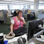 CENTER OF ATTENTION: Blue Cross & Blue Shield of Rhode Island representative Jeanne Fraoli works 
in the company’s 
Customer and Provider Services Center.

PHOTO COURTESY BCBSRI / 