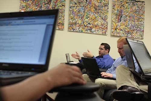 STRONG NETWORK: Atrion Corp. systems developer Josh Cliff, above with glasses, in a meeting at the company’s Warwick office. / STRONG NETWORK: Atrion Corp. systems developer Josh Cliff, above with glasses, in a meeting at the company’s Warwick office. /