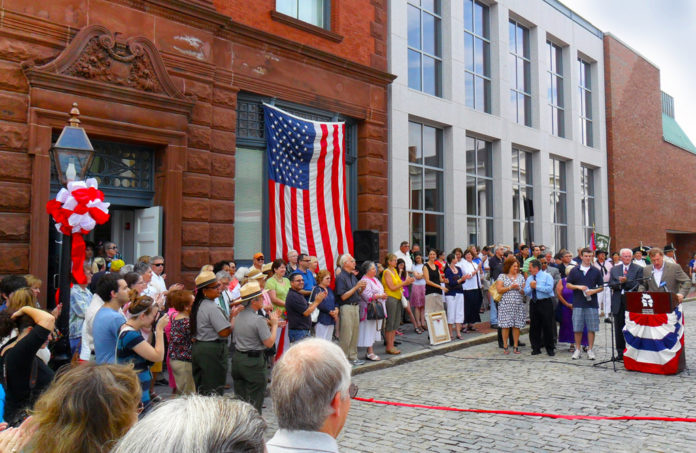 New Bedford Whaling Museum President James Russell addresses the crowd Saturday at a ribbon cutting ceremony celebrating the reopening of the Whaling Museum's 1906 entrance to its newly restored Old Dartmouth Historical Society - Wattles Family Gallery. / New Bedford Whaling Museum President James Russell addresses the crowd Saturday at a ribbon cutting ceremony celebrating the reopening of the Whaling Museum's 1906 entrance to its newly restored Old Dartmouth Historical Society - Wattles Family Gallery. /