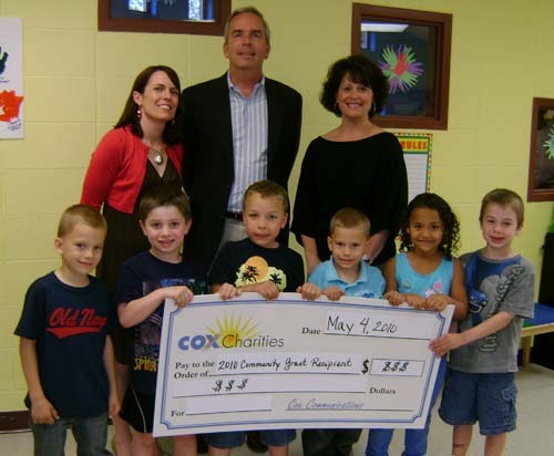 FROM LEFT: Amy Quinn, director of public affairs for Cox Communications, and Mike Miner, director of quality solutions for Cox Communications and board member of the Boys and Girls Clubs, present Lara D’Antuono, executive director of Boys and Girls Clubs of Warwick, and children from the club with a $15,000 grant. / FROM LEFT: Amy Quinn, director of public affairs for Cox Communications, and Mike Miner, director of quality solutions for Cox Communications and board member of the Boys and Girls Clubs, present Lara D’Antuono, executive director of Boys and Girls Clubs of Warwick, and children from the club with a $15,000 grant. /