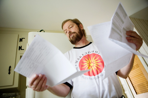 MOUNTING COSTS: Barrington resident Kevin Kurowski was diagnosed with cancer in July 2009. He is in remission, but still takes the costly drug ATRA. Above, he sorts though bills for his treatment. / MOUNTING COSTS: Barrington resident Kevin Kurowski was diagnosed with cancer in July 2009. He is in remission, but still takes the costly drug ATRA. Above, he sorts though bills for his treatment. /
