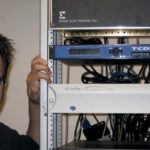 JASON BENJAMIN, who heads the Norton cable access agency, sees not only improved capabilities in the new fiber-optic system, but lower costs for the town. / 