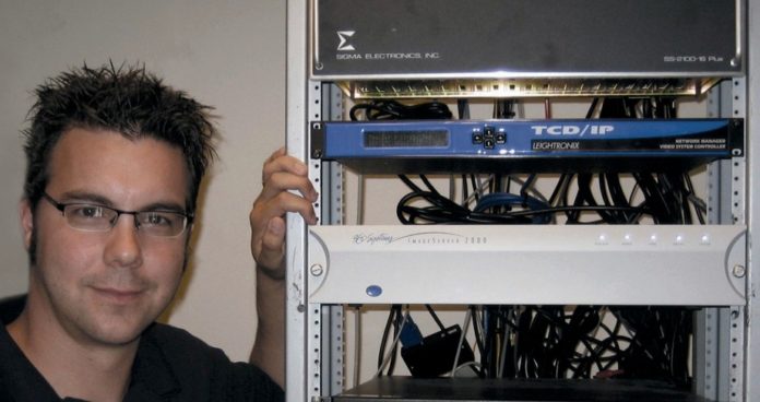 JASON BENJAMIN, who heads the Norton cable access agency, sees not only improved capabilities in the new fiber-optic system, but lower costs for the town. / 