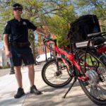 GETTING AROUND: Tony LeDoux, a RISD public safety officer, shows off the electric bicycle the school recently purchased for patrols. / 